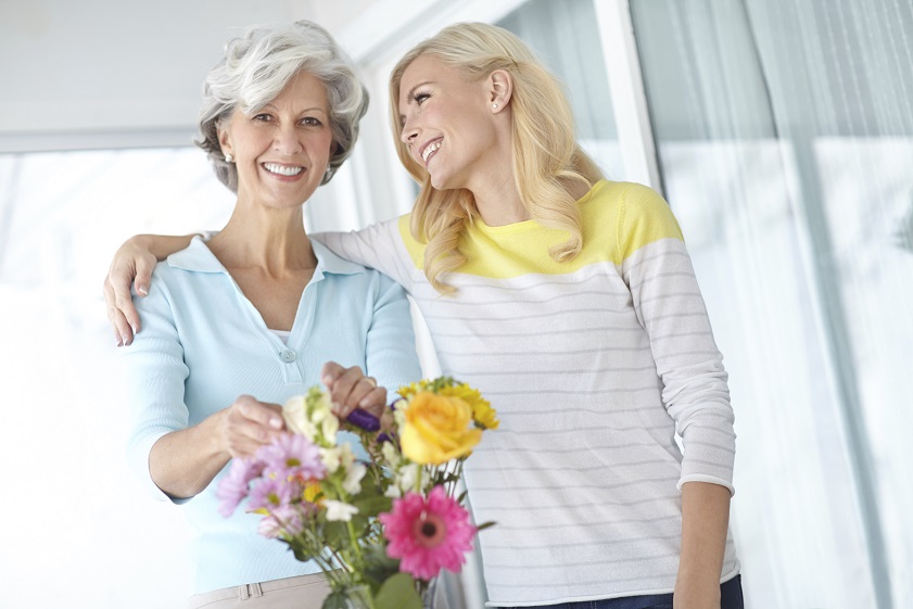 Learning from the master Portrait of a senior woman enjoying some flower arranging with her daughter